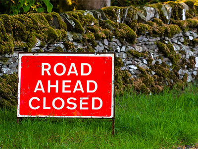 Sign showing Road Ahead Closed message