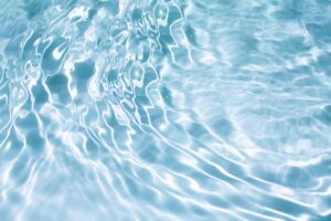 Light,Blue,Water,With,Ripples,On,The,Surface.,Defocus,Blurred