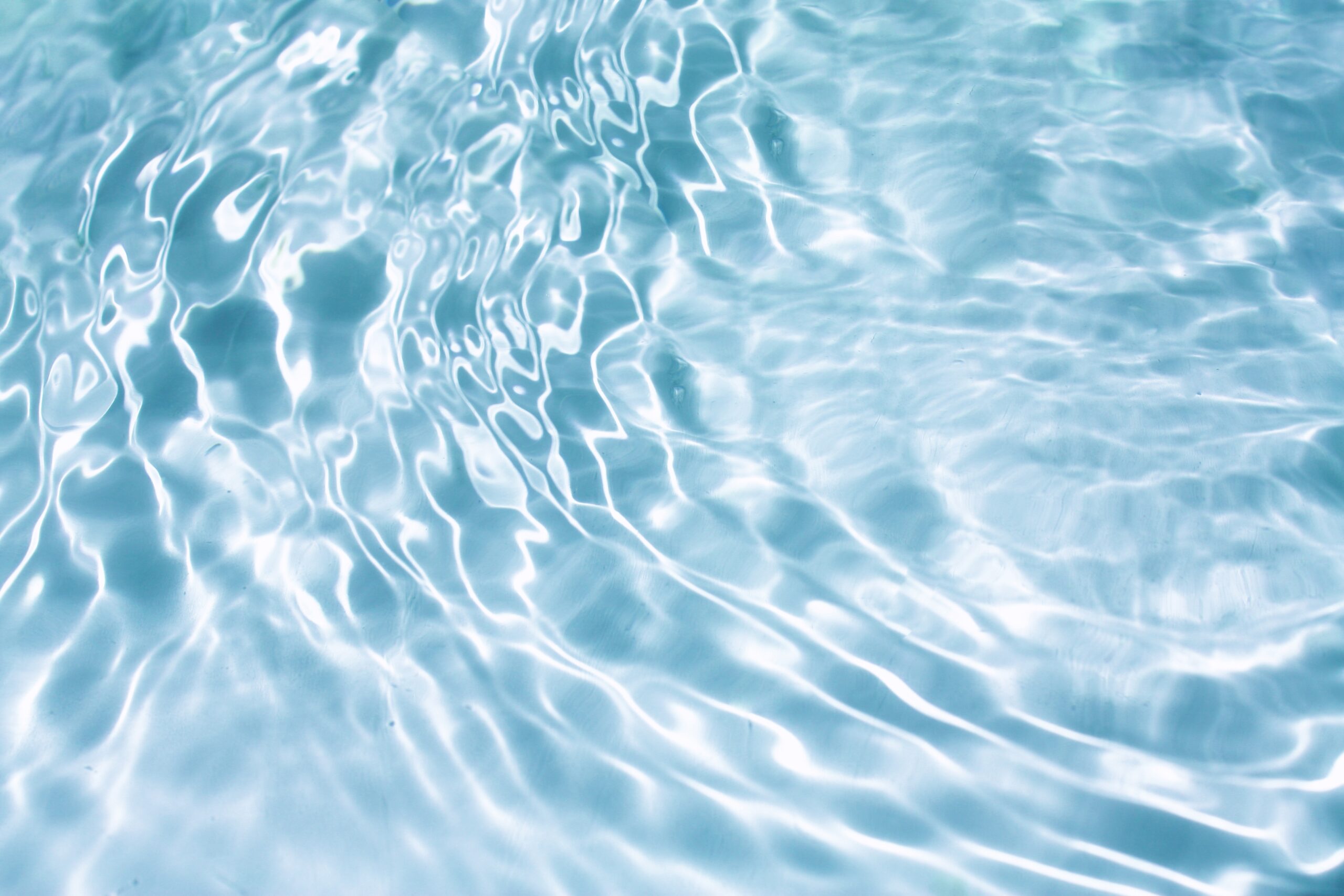 Light,Blue,Water,With,Ripples,On,The,Surface.,Defocus,Blurred